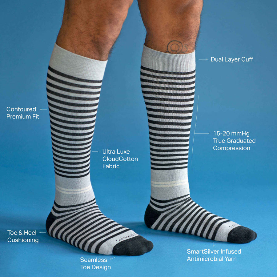 Side view of feet wearing a cotton compression socks in black-mulberry tencel stripe