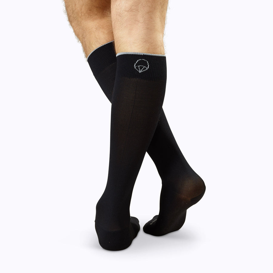 Back view of legs wearing Knee-High Compression Socks in solid black