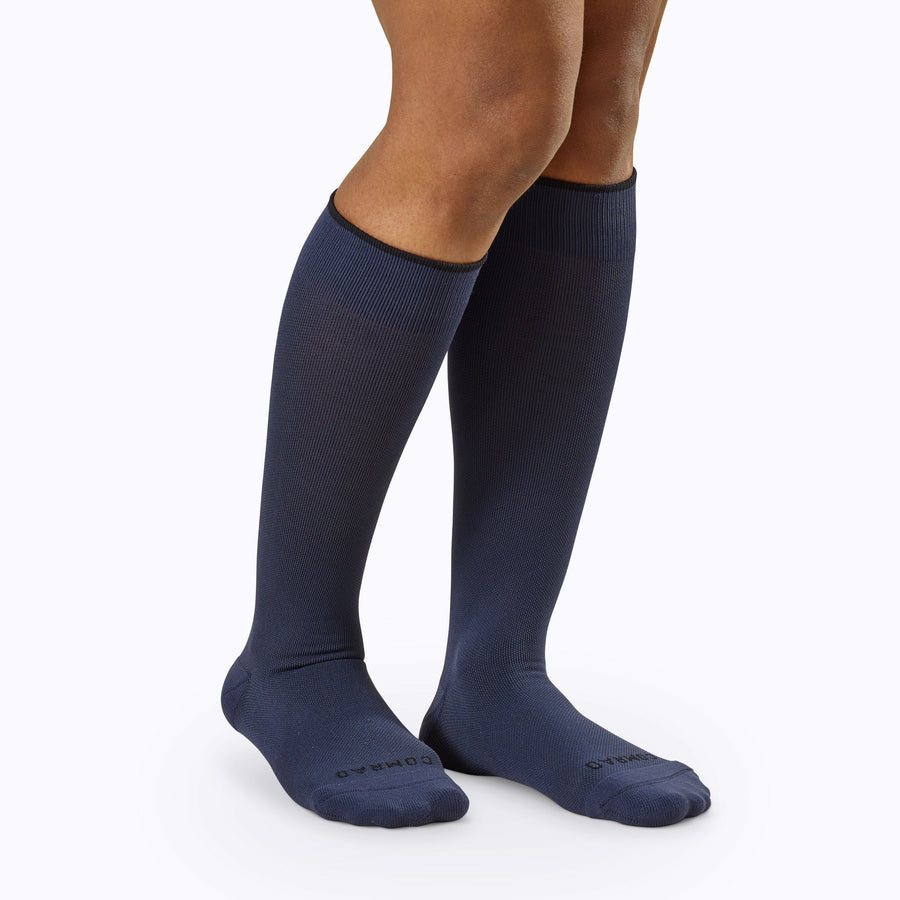 Front view of legs wearing knee high compression socks in navy