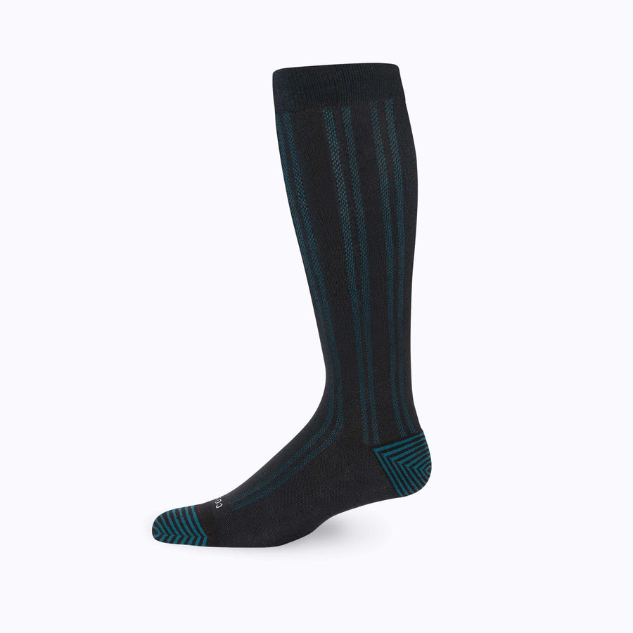 Side view of knee high compression socks in black-blue-sage