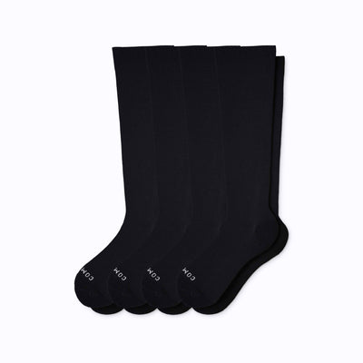 A 4-pack nylon knee high compression socks in black solid