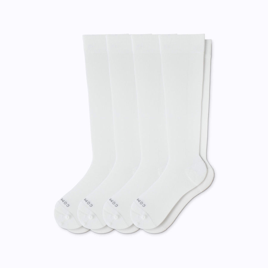 A 4-pack nylon knee high compression socks in white solid