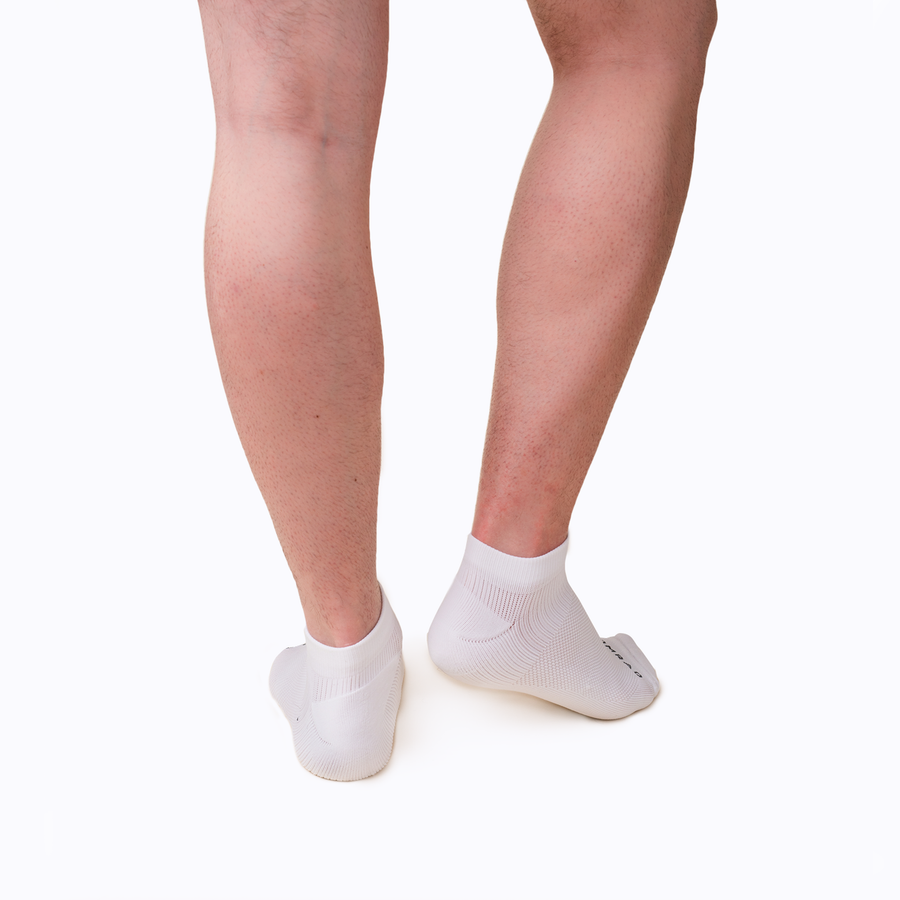 Back view of feet wearing nylon ankle compression socks in white solid