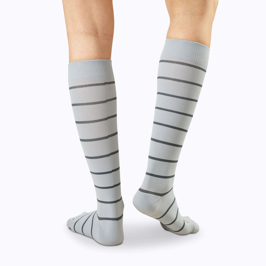 Back view of legs wearing  Knee-High Compression Socks in grey-charcoal stripes