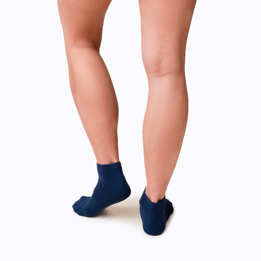 Back view of feet wearing nylon ankle socks in navy solid
