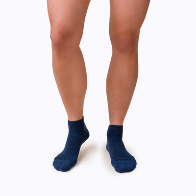 Front view of feet wearing nylon ankle compression socks in navy solid
