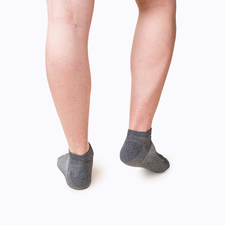 Back view of feet wearing nylon ankle compression socks in charcoal solid