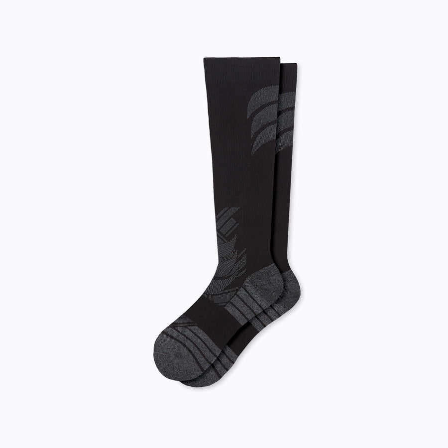 A pair of athletic knee high performance blend socks black solid