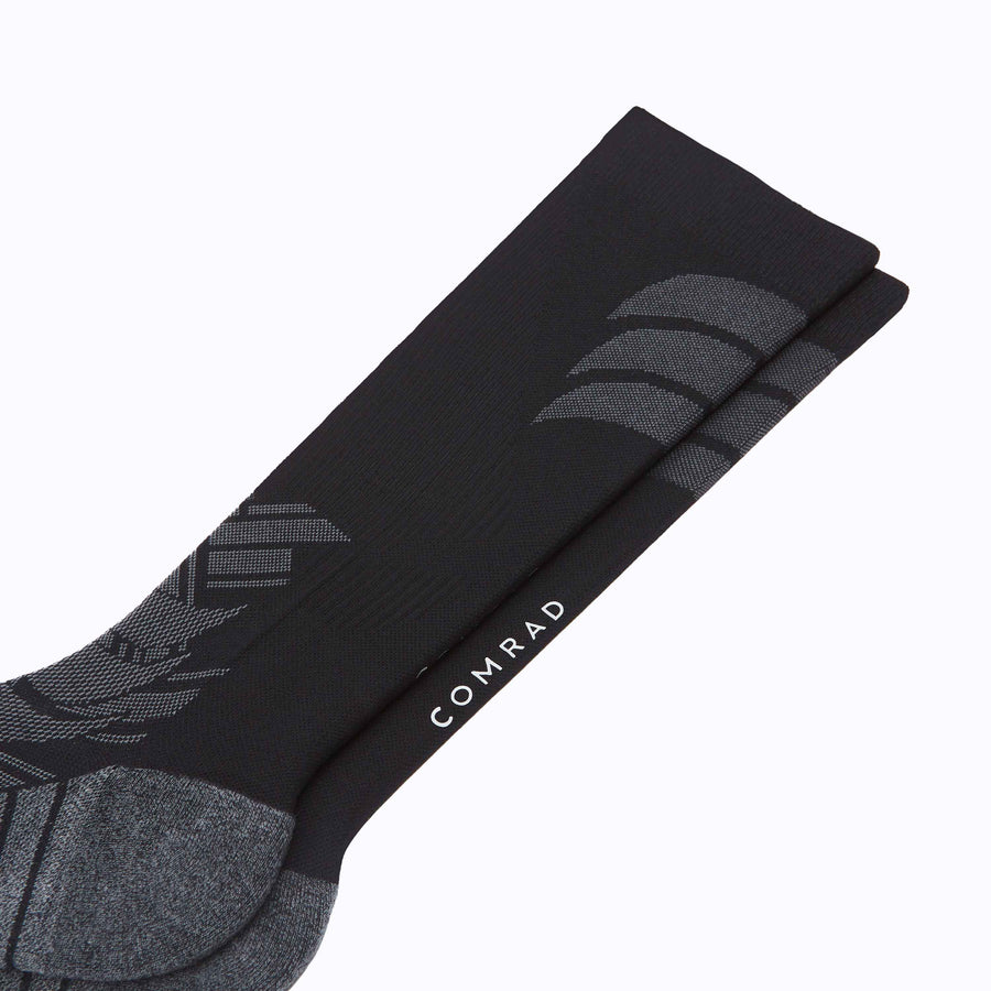 Close up view of the athletic knee high performance blend socks black solid
