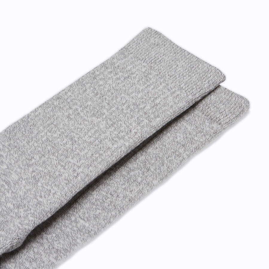 Close up view of a pair of combed cotton crew socks in heather grey solid