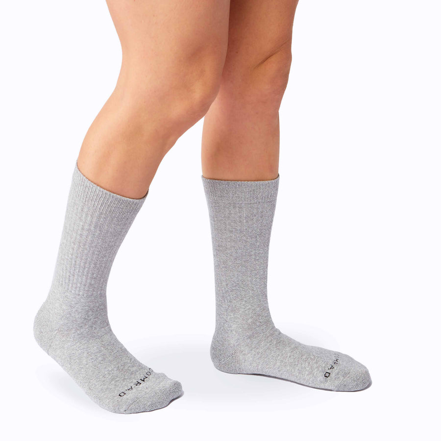 Side view of legs wearing the combed-cotton crew socks in heather grey solid