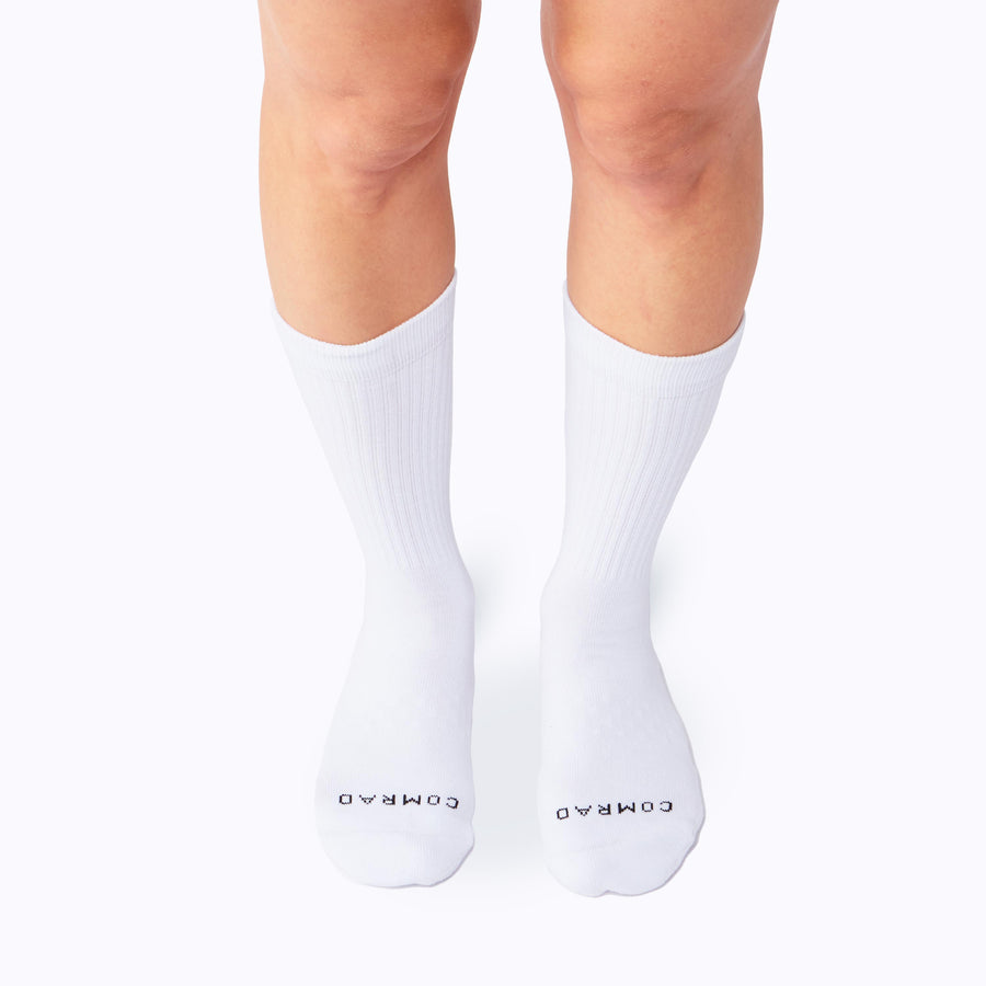 Front view of legs wearing the combed cotton crew socks in white solid