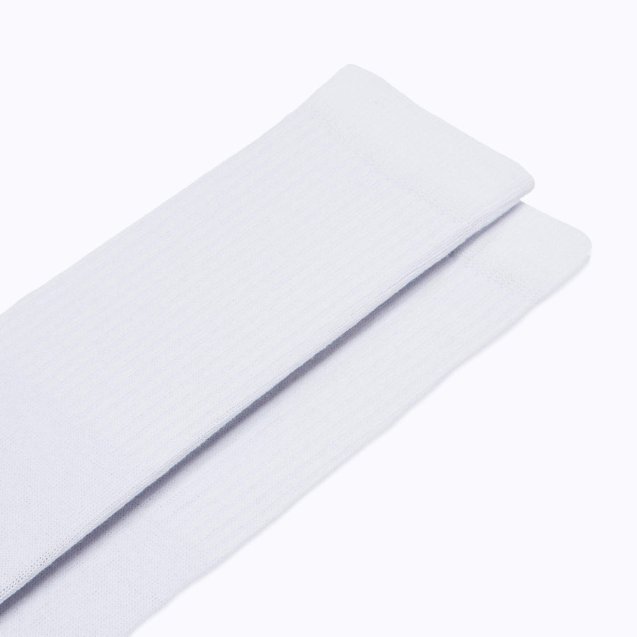 Close up view of a pair of combed-cotton socks in  white solid