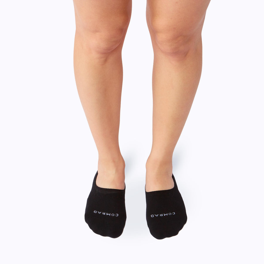 Front view of feet wearing the combed cotton loafer liners in black solid