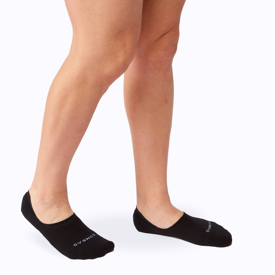 Side view of feet wearing the combed cotton loafer liners in black
