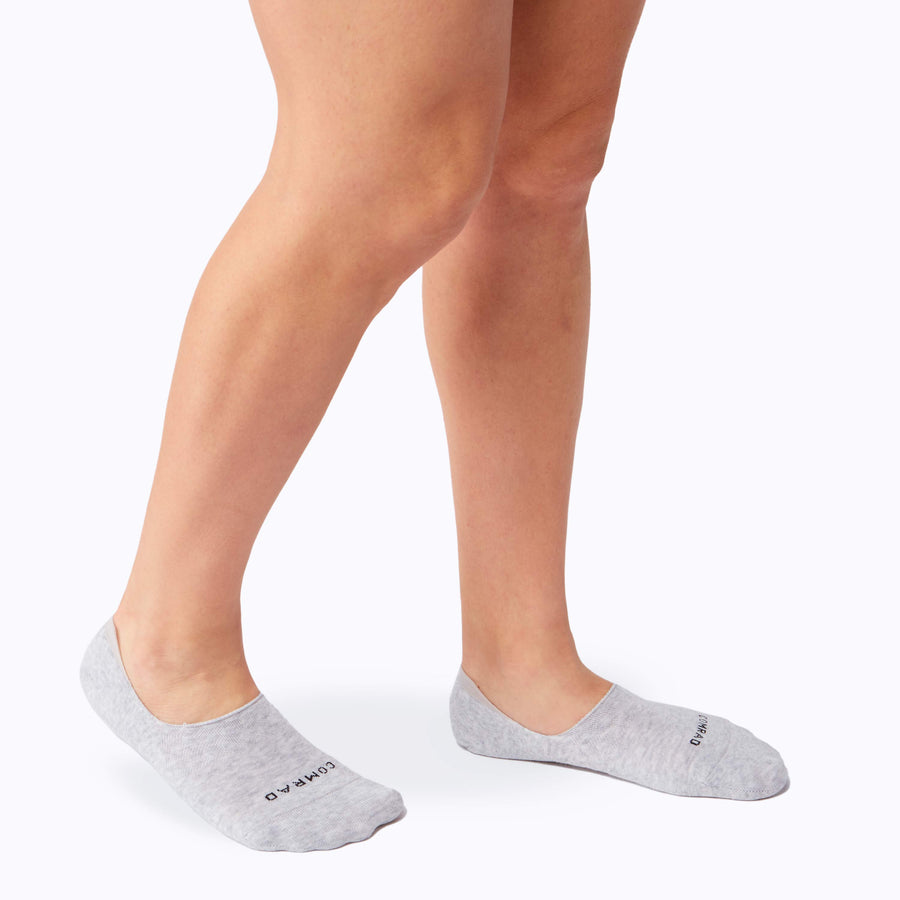Side view of feet wearing the combed cotton loafer liners in heather grey