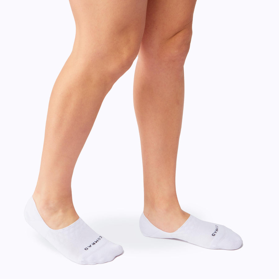 Side view of feet wearing the combed cotton loafer liners in white