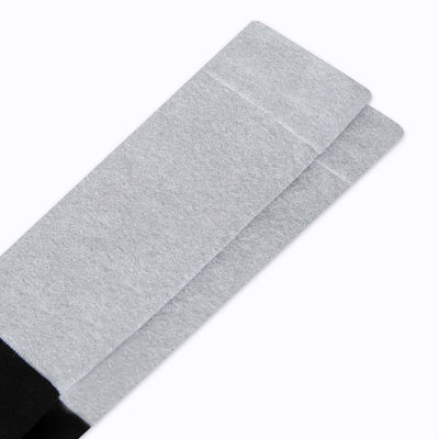 Close up view of knee high cotton compression socks in grey-black tencel colorblock