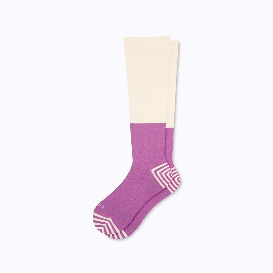 A pair of knee high cotton compression socks in cream-mulberry tencel colorblock