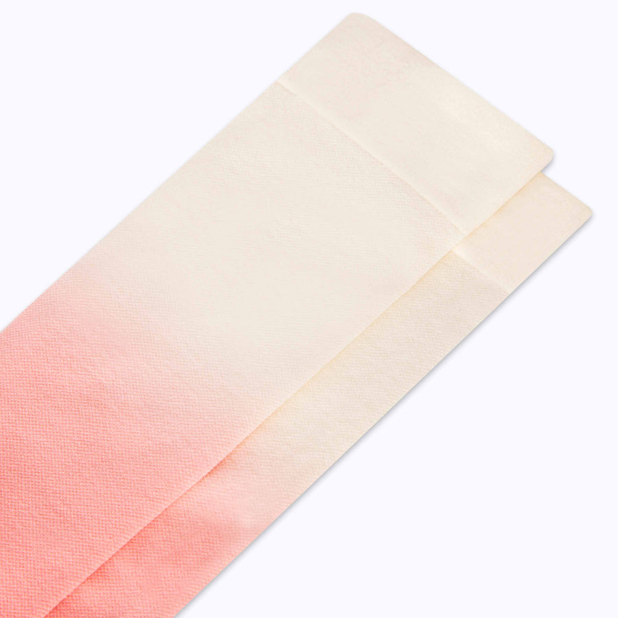 Close up view of knee high nylon socks in cream-terracotta ombre 
