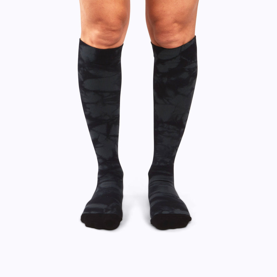 Front view of legs wearing a nylon knee high compression socks in black twist-dye