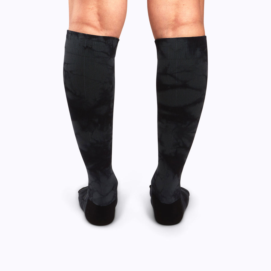 Back view of legs wearing a nylon knee high compression socks in black twist