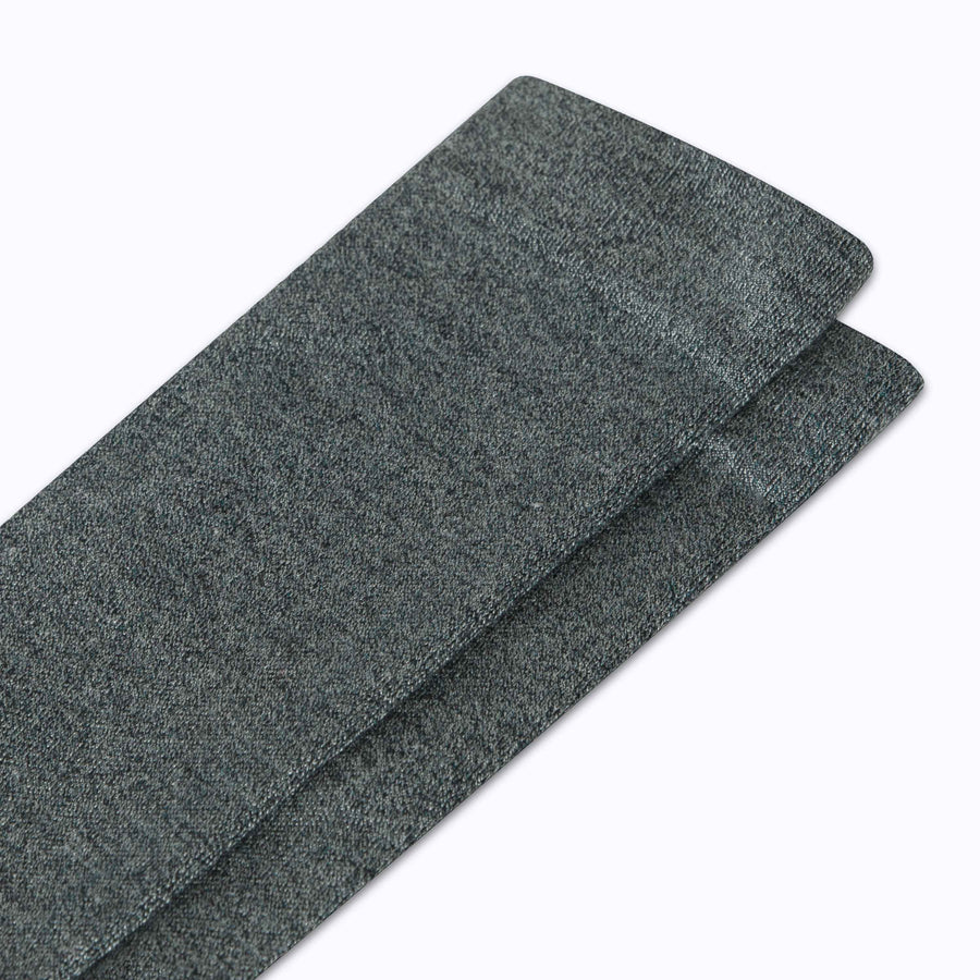 Close up view of merino knee high compression socks in black-sage tencel stripes