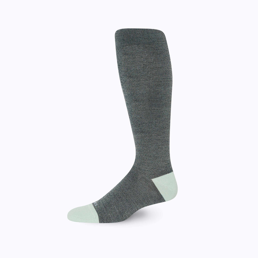 Side view of merino knee high compression socks in black-sage tencel stripes
