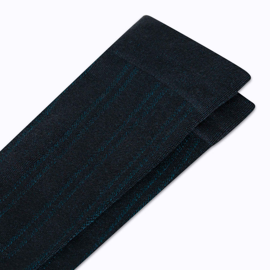 Close up view of merino knee high compression socks in black-botanical tencel stripes