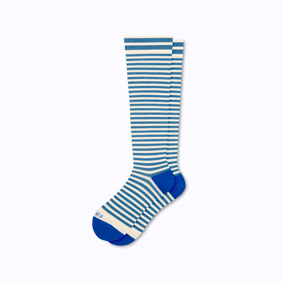 A pair of merino knee high compression socks in blue-sand tencel stripes